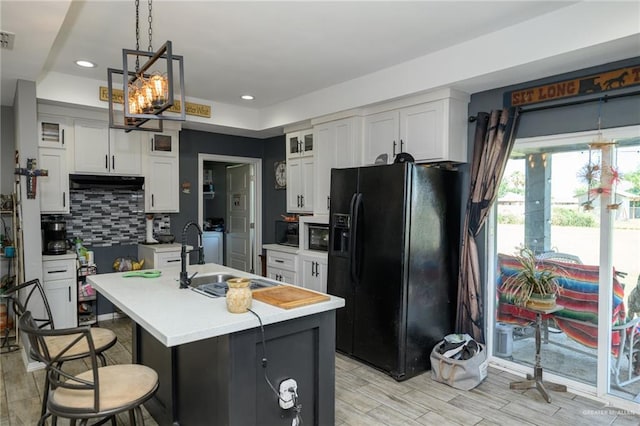 4511 Abbey St, Mercedes, TX 78570 - kitchen featuring black appliances, a sink, light countertops, glass insert cabinets, and backsplash