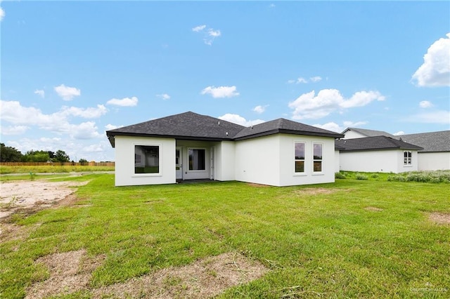 rear view of property with a lawn