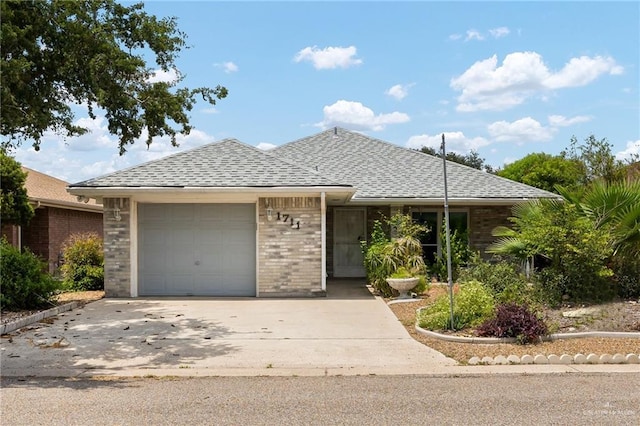 1711 Sun St, Mission, TX 78572 - ranch-style home featuring an attached garage, roof with shingles, brick siding, and driveway