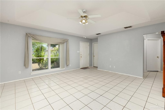 1711 Sun St, Mission, TX 78572 - empty room with ceiling fan, a tray ceiling, and baseboards