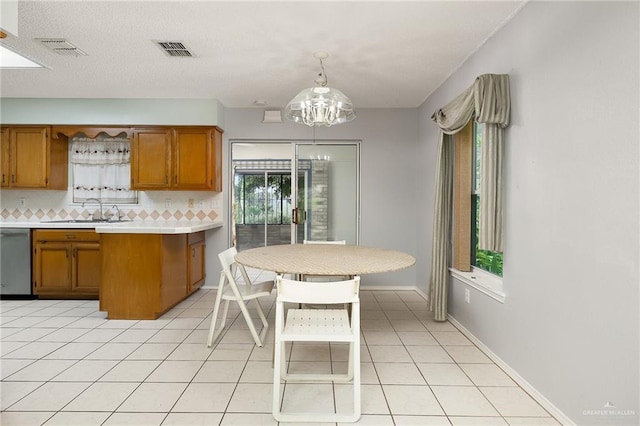 1711 Sun St, Mission, TX 78572 - kitchen featuring a sink, brown cabinetry, stainless steel dishwasher, and light countertops