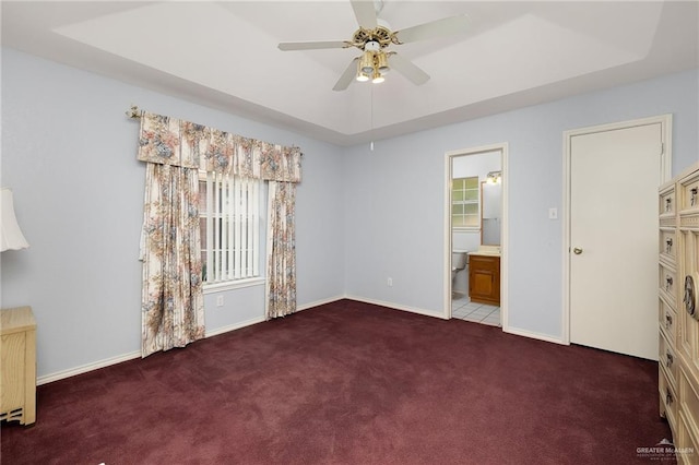 1711 Sun St, Mission, TX 78572 - unfurnished bedroom featuring carpet, baseboards, a tray ceiling, ensuite bathroom, and a ceiling fan