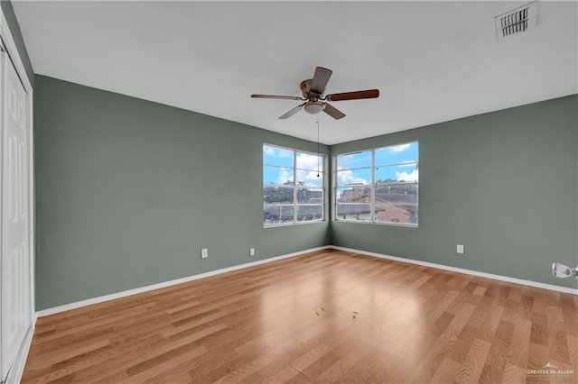 spare room featuring ceiling fan and light hardwood / wood-style flooring