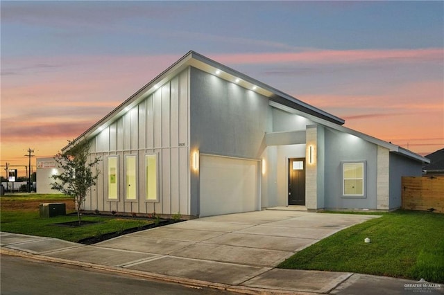 modern home featuring a lawn and a garage