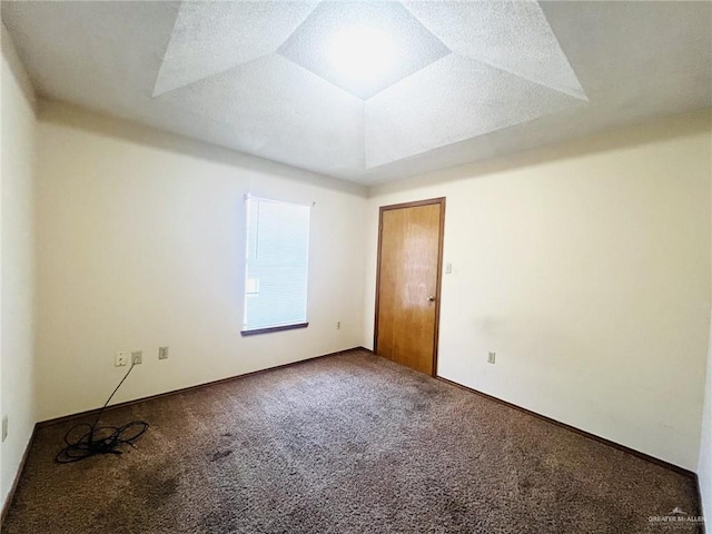 carpeted spare room featuring a textured ceiling