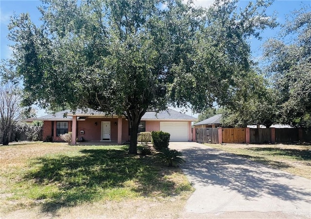 ranch-style house with a front yard and a garage