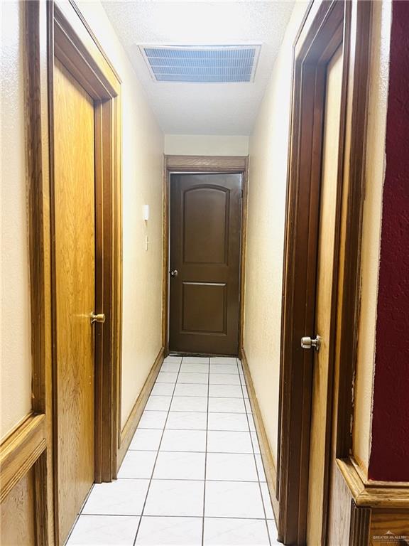 hall featuring light tile patterned floors