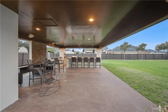 view of patio / terrace featuring outdoor dry bar and a fenced backyard