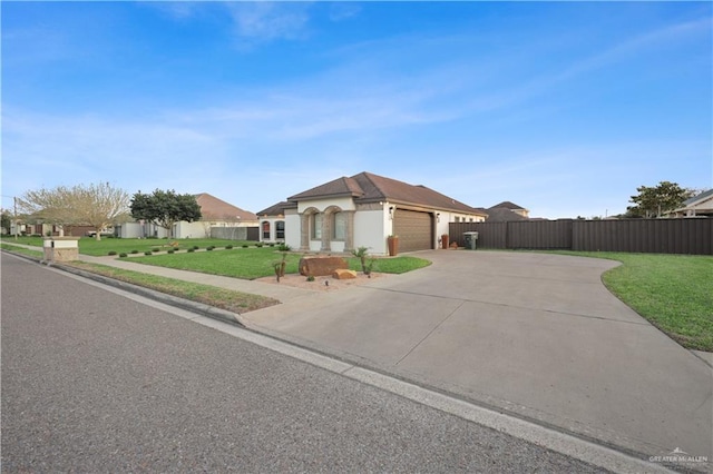 view of front facade with a garage, fence, driveway, and a front lawn