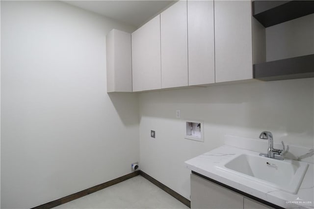 washroom featuring hookup for an electric dryer, hookup for a washing machine, cabinets, and sink