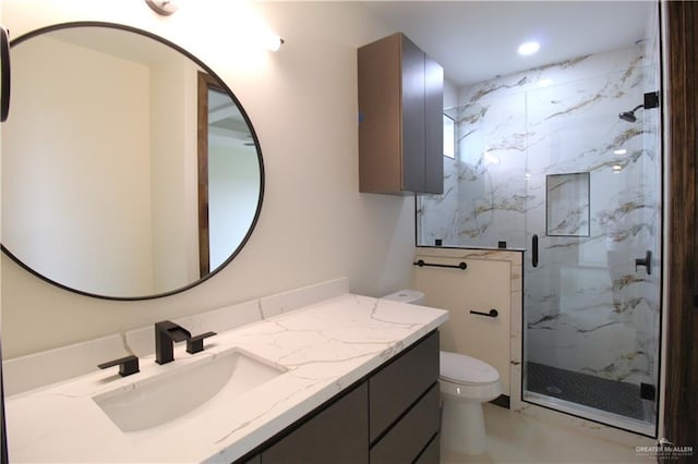 bathroom featuring vanity, toilet, and an enclosed shower