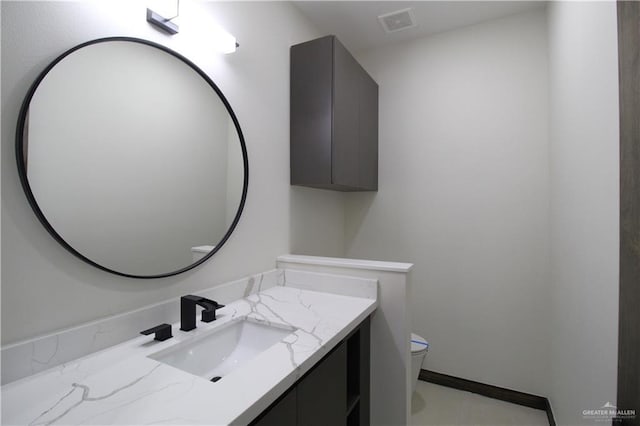 bathroom with vanity and toilet