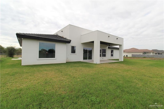 rear view of house with a patio area and a yard