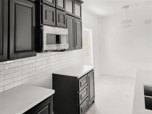 kitchen with backsplash and decorative light fixtures