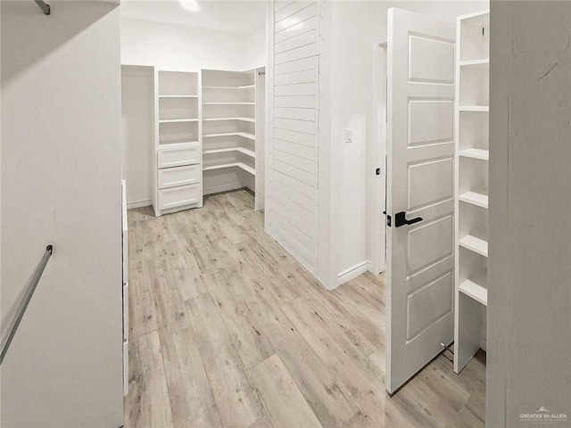 spacious closet featuring light hardwood / wood-style floors