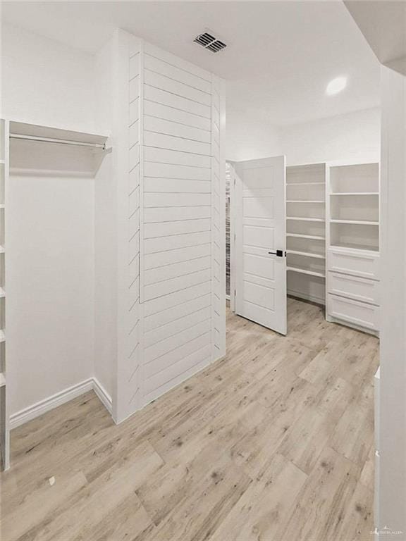 spacious closet featuring light hardwood / wood-style flooring