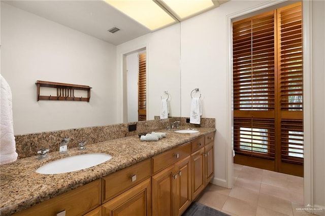 bathroom with tile patterned flooring and vanity