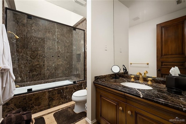 full bathroom featuring toilet, vanity, and tiled shower / bath