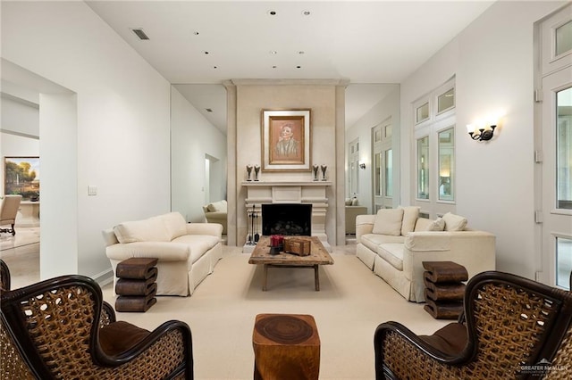 carpeted living room with a large fireplace