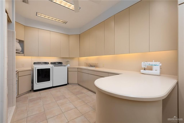 kitchen with washer and clothes dryer, light tile patterned flooring, kitchen peninsula, and sink