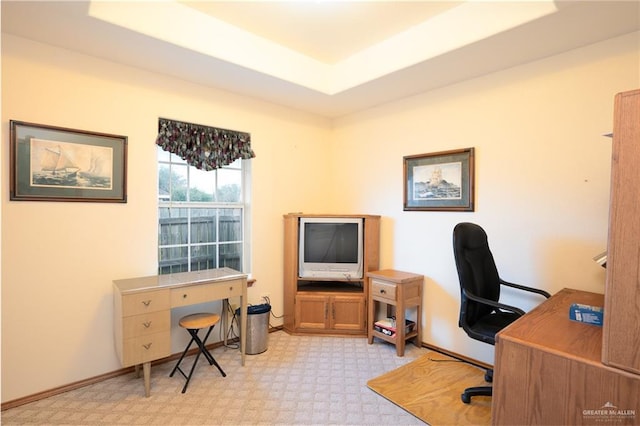 office with light colored carpet and a raised ceiling