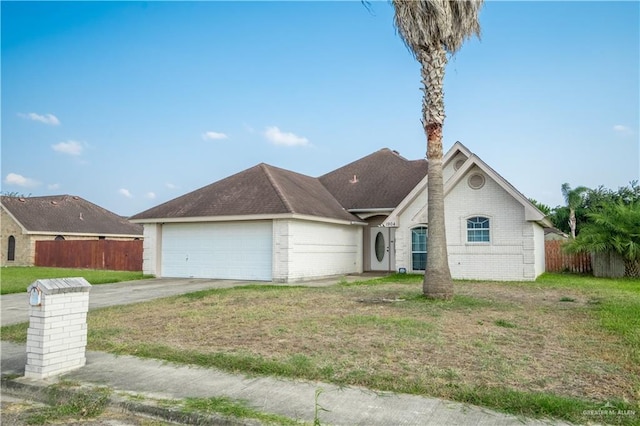 ranch-style house featuring a front yard and a garage