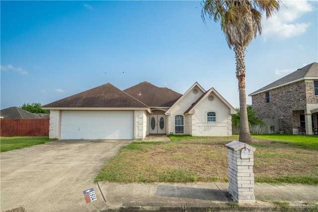 view of front of house featuring a garage and a front lawn