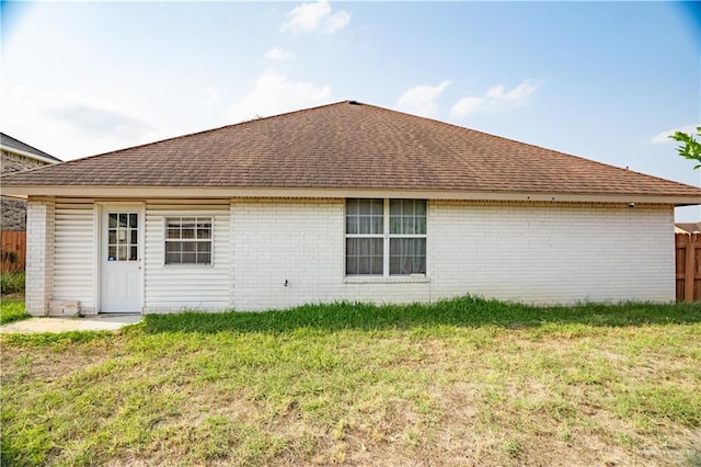 rear view of property with a lawn