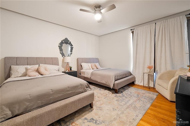 bedroom with hardwood / wood-style flooring and ceiling fan