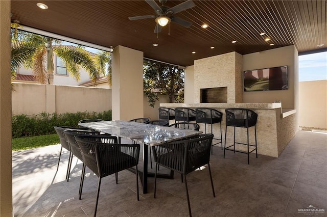 view of patio / terrace with ceiling fan and an outdoor bar