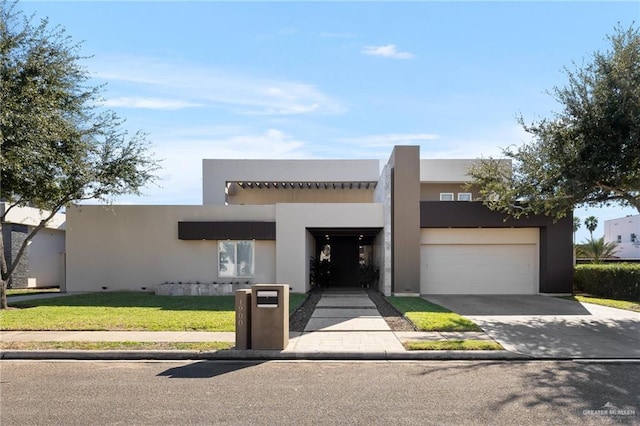 pueblo revival-style home with a garage and a front lawn