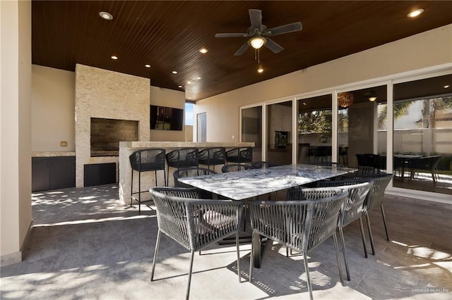 view of patio with an outdoor bar and ceiling fan