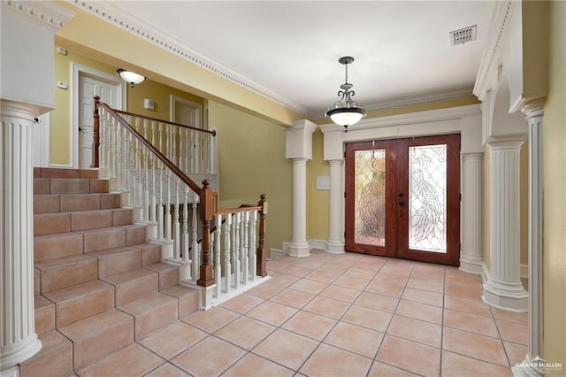 foyer with french doors, crown molding, and light tile patterned flooring