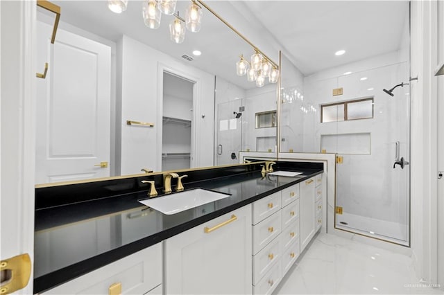 bathroom featuring an enclosed shower and vanity