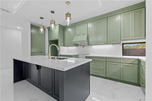 kitchen with a kitchen island with sink, sink, extractor fan, and green cabinets