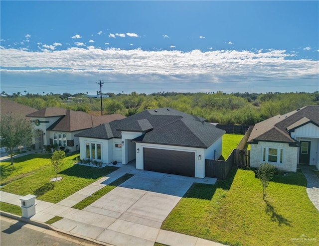 view of front of house featuring a front lawn and a garage