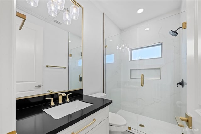 bathroom featuring an enclosed shower, vanity, and toilet