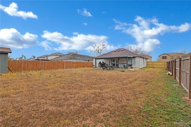 view of yard with a fenced backyard and a patio