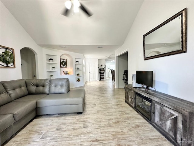 712 Bridget St, Weslaco, TX 78596 - living area with a ceiling fan, lofted ceiling, built in features, arched walkways, and light wood-type flooring