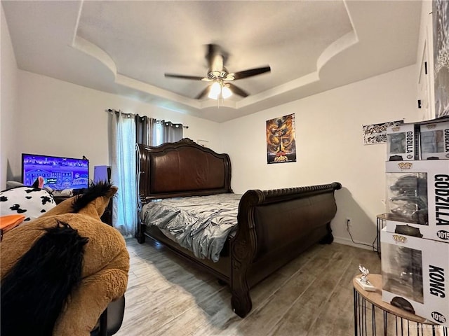 712 Bridget St, Weslaco, TX 78596 - bedroom with a tray ceiling, wood finished floors, and ceiling fan
