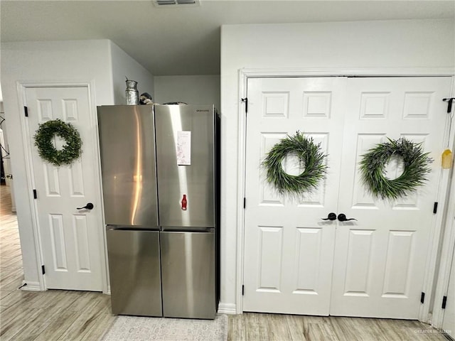 712 Bridget St, Weslaco, TX 78596 - kitchen with freestanding refrigerator and light wood-style flooring