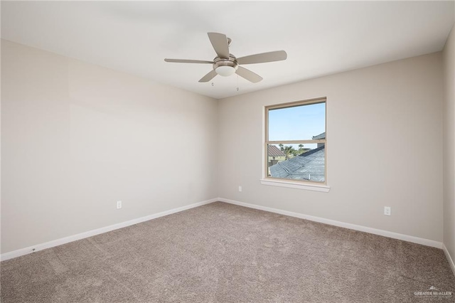 empty room with ceiling fan, carpet flooring, and baseboards