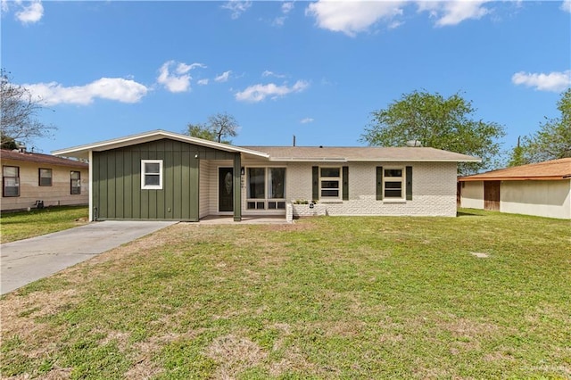 single story home with brick siding, board and batten siding, and a front yard