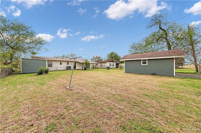 view of yard with an outbuilding and fence