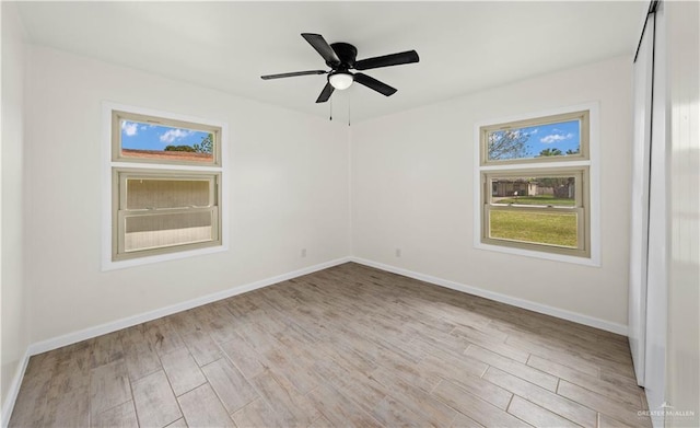 spare room featuring ceiling fan, wood finished floors, and baseboards