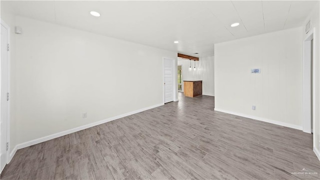 unfurnished living room featuring recessed lighting, visible vents, baseboards, and wood finished floors