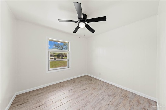 empty room featuring light wood-style floors, baseboards, and a ceiling fan