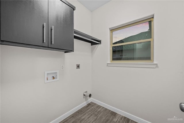 washroom featuring cabinets, dark hardwood / wood-style flooring, washer hookup, and hookup for an electric dryer