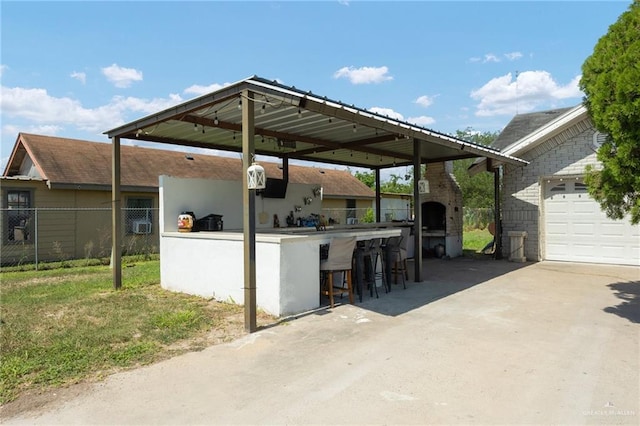 view of patio featuring a fireplace and an outdoor bar