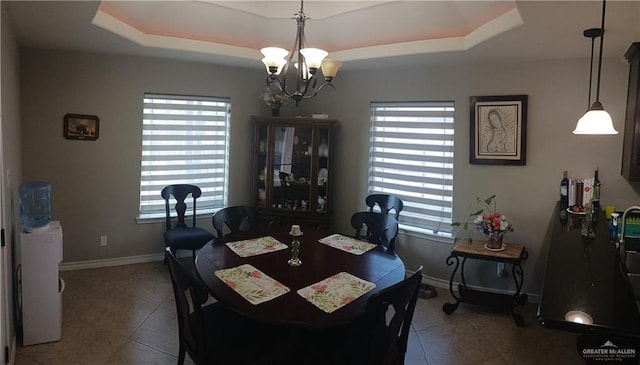 1805 Black Stone St, Edinburg, TX 78542 - dining area featuring a tray ceiling, tile patterned floors, a chandelier, and baseboards